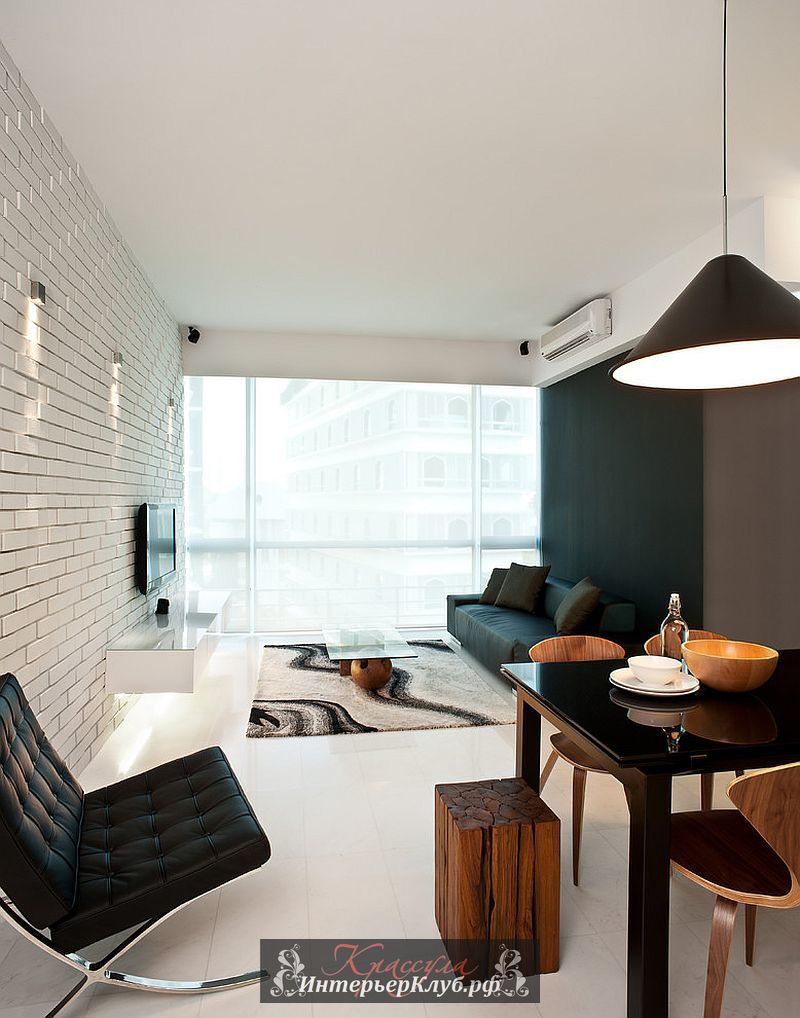 8 Черно-белый интерьер гостиной с кирпичной стеной и кресло Барселона