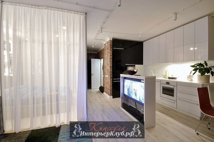 Умная ТВ-зона разграничивает кухню от жилого пространства и служит небольшим кухонным островом